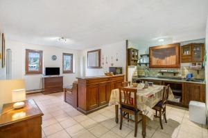 a large kitchen with a table in a room at Valtournenche, monolocale in centro in Valtournenche +6 photos