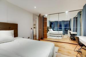 a bedroom with a bed and a desk and a mirror at Still Life Warren Street in London
