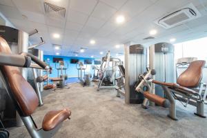 a gym with treadmills and cardio machines at Holiday Inn Edinburgh Zoo, an IHG Hotel in Edinburgh