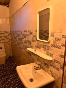 a bathroom with a sink and a mirror at YOGA SHACK in Arugam Bay