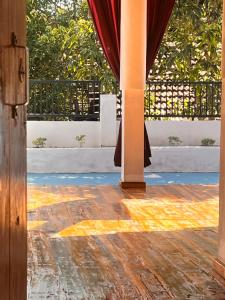 an open door to a patio with a curtain at YOGA SHACK in Arugam Bay