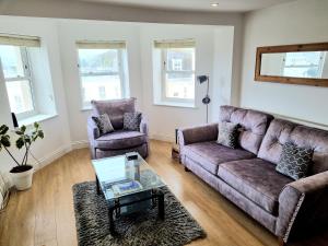 a living room with a couch and two chairs at River Views, Free Parking, Near Royal William Yard in Plymouth