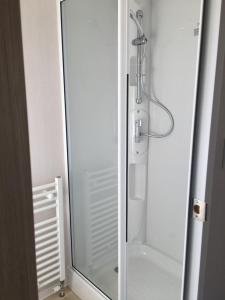 a shower with a glass door in a bathroom at Miss Grace Plot 26 in Ingoldmells