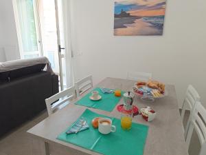 a table with breakfast foods and drinks on it at Appartamento casa Ammare in Montesilvano