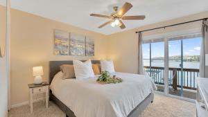 a bedroom with a bed and a ceiling fan at VIEWS! Lakefront Family Home - Swim Dock - 3 Decks in Osage Beach