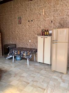 a kitchen with a refrigerator and a table in it at QUARTO UNIFESP Prox RODOVIAS, MARGINAS, ALPHAVILLE in Osasco