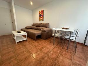 - un salon avec un canapé et une table dans l'établissement Apartamentos Alma de Zahara, à Zahara de los Atunes