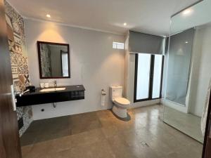 a bathroom with a toilet and a sink and a shower at Ivory Mountain Villa in Hòa Bình +15 photos