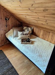 a bed in a sauna with a wooden ceiling at Haukland Panorama in Offersøya