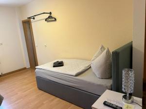 a room with a bed with a lamp and a desk at Ferienwohnung Falkeneck in Lautertal