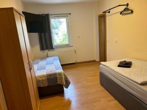 a room with two beds and a window at Ferienwohnung Falkeneck in Lautertal