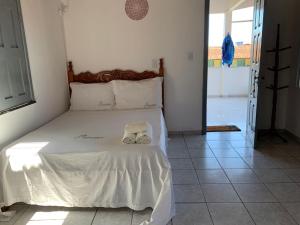 Recanto do Porto _ Hospedagem tesisinde bir odada yatak veya yataklar
