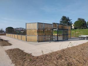 a gate in a park with a playground at T2 avec Piscine exclusive in Bourg-Saint-Bernard