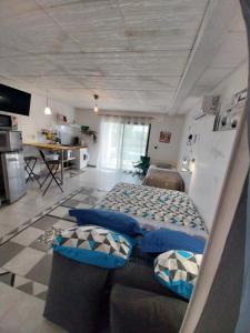 a large room with two beds and a kitchen at T2 avec Piscine exclusive in Bourg-Saint-Bernard