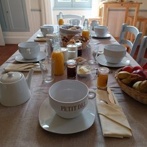 a table topped with a table set with breakfast food at Baladous in Montgaillard-de-Salies
