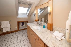 a bathroom with a sink and a mirror at The Ormond Apartments in Dungarvan