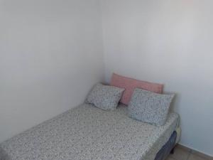 een bed met drie kussens in een kamer bij Hacienda 85 in Ahuachapán