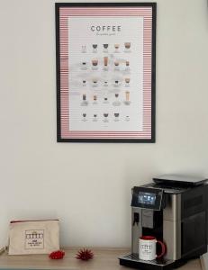 a poster of coffee on a wall above a coffee machine at B&B Santa Maria Di Leuca in Leuca