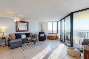 un soggiorno con divano e balcone di Sunbird #1002E a Panama City Beach