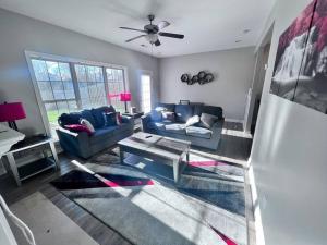 a living room with a couch and a table at TWO-STORY Townhouse Kentucky Horse Park at Kittens Joy in Lexington