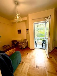 a living room with a green couch and a table at Sky Guest House in Tbilisi City