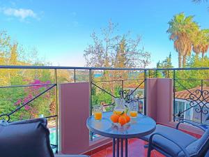 a table with oranges on top of a balcony at Okeanis Apartments & Suites Adults Only in Katelios