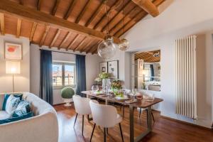 a dining room with a table and chairs at De Nobili Penthouse Apartment with Elevator in Lucca in Lucca
