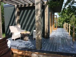 a wooden deck with a bench and a table at The Chilterns View in Wallingford