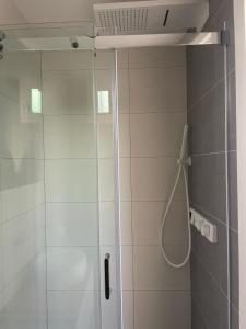 a shower with a glass door in a bathroom at Esmeralda in Palma de Mallorca