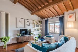 a living room with a couch and a table at De Nobili Penthouse Apartment with Elevator in Lucca in Lucca