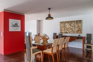 a dining room with a table and chairs at Azores Dreams - Sea View House in São Roque