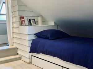 a bedroom with a bed in a white wall at Superbe duplex, Centre historique, 5 personnes in Bellême +18 photos