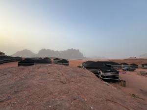 a group of tents on top of a dirt field at Star World Camp in Wadi Rum