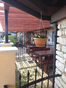 a patio with a table and a pot of flowers at Monte studio app 3 in Umag
