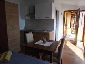 a kitchen with a wooden table and a dining room at Monte studio app 3 in Umag +4 photos