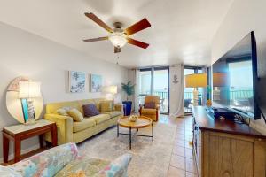 a living room with a couch and a ceiling fan at Phoenix VI 807 in Orange Beach