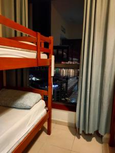 a bedroom with a bunk bed and a window at Bohemian Backpackers in Dubai