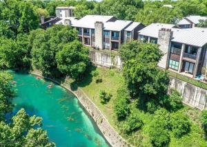 an aerial view of a large house next to a river at Comal Rive Pool Gruene Hall by Barclé in New Braunfels
