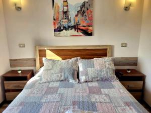 - une chambre avec un lit et une peinture murale dans l'établissement Condominio Pacífico III, à La Serena