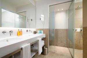 a bathroom with a sink and a shower at Hotel Kivir in Seville