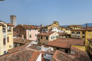 a view of roofs of a city with buildings at De Nobili Penthouse Apartment with Elevator in Lucca in Lucca