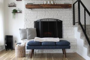 a blue couch sitting in front of a fireplace at Modern Getaway - New Outdoor Amenities! - Location in Osage Beach