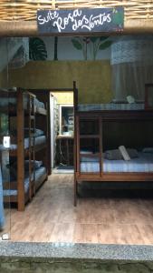 a room with three bunk beds and a mirror at Sitio Simple Life in Ubatuba