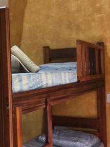 a bunk bed with a wooden frame with at Sitio Simple Life in Ubatuba