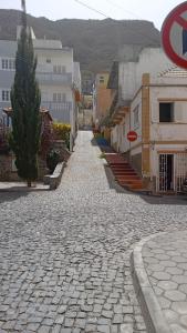 a cobble stone street in a town with buildings at CasaMrichica1 in Ribeira Grande