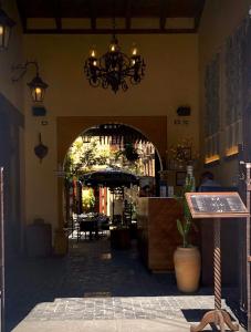 an entrance to a restaurant with a chandelier in a building at Mestizo Antigua in Antigua Guatemala