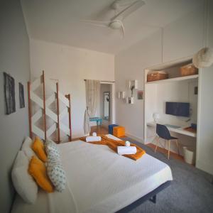 a bedroom with a large bed and a desk at Alojamentos Vista Mar-Luisa Todi in Setúbal