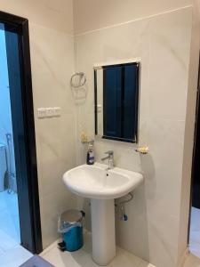a bathroom with a white sink and a mirror at مشار العلا AL ULA in Al-ʿUla