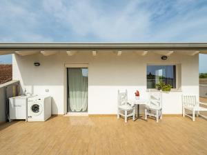 a patio with a washing machine and a table and chairs at Casa Giovele in Selargius