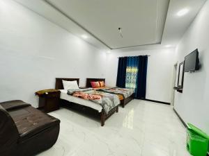 a bedroom with a bed and a couch and a tv at Zaib Guest House for Families Only in E-11 Islamabad in Islamabad +7 photos
